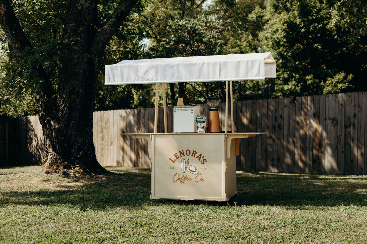 Cartssify mobile coffee cart set up with an espresso machine and grinder in a hotel lobby